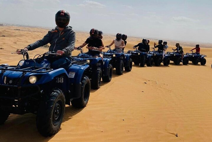Experience the joy of racing across the stunning red dunes on a Quad Bike blending adventure with the rich culture of the desert and unforgettable entertainment.